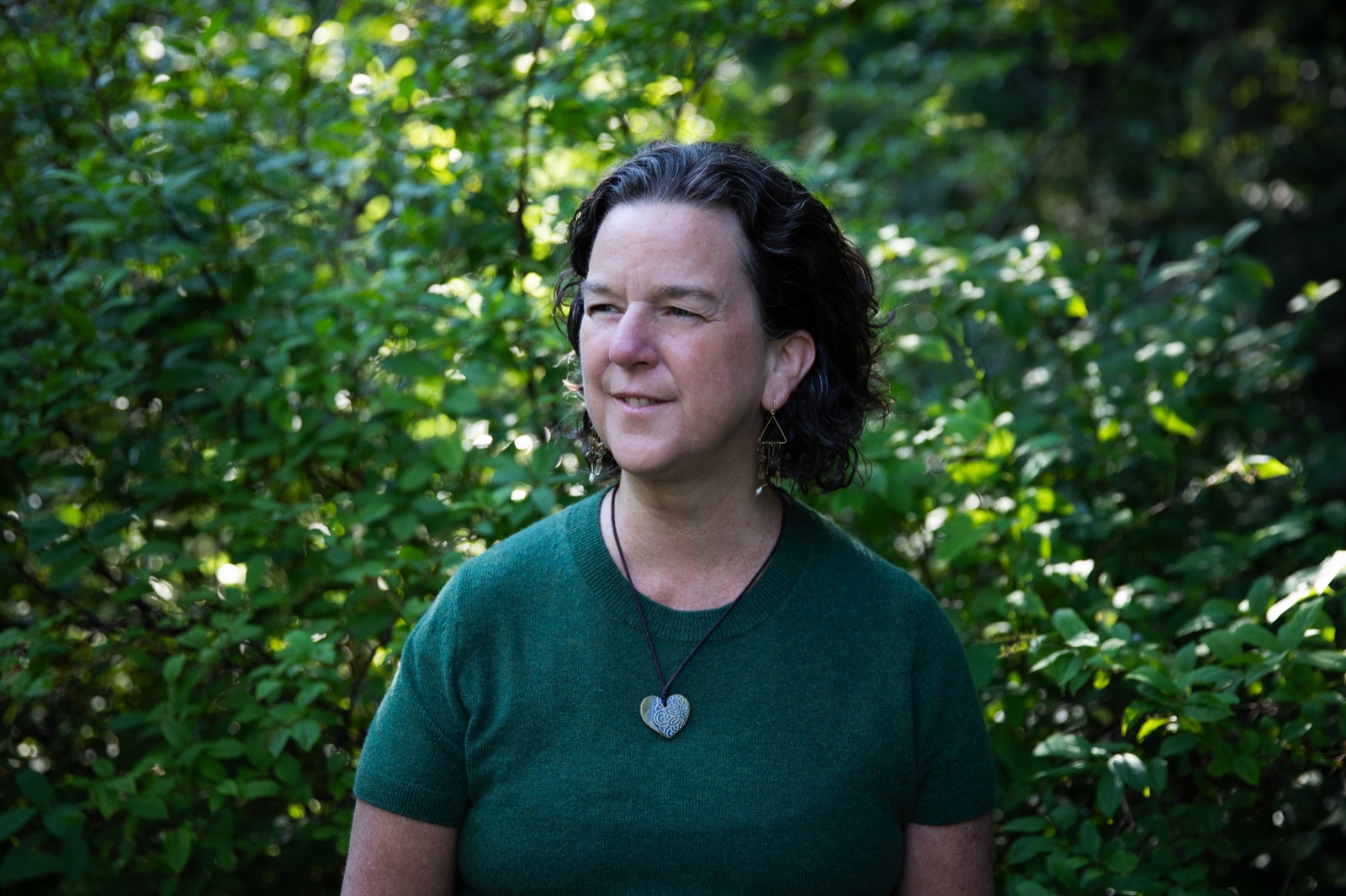 Dr. Meg Moss in profile, surrounded by greenery